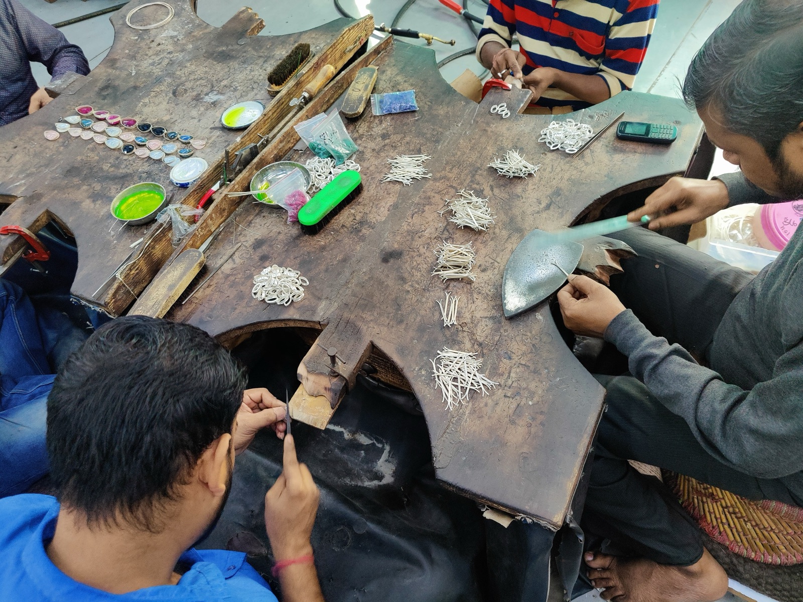 Silver components being cut, filed and assembled at the workbench